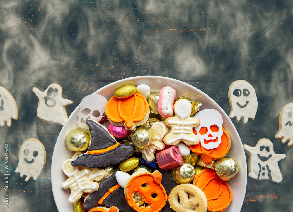 candy bowl with Halloween treats homemade thematic spooky cookies and candy sweets. Happy Halloween Jack o Lantern and Trick or Treat candy bowl with Halloween treats homemade thematic spooky cookies and candy sweets. Happy Halloween Jack o Lantern and Trick or Treat