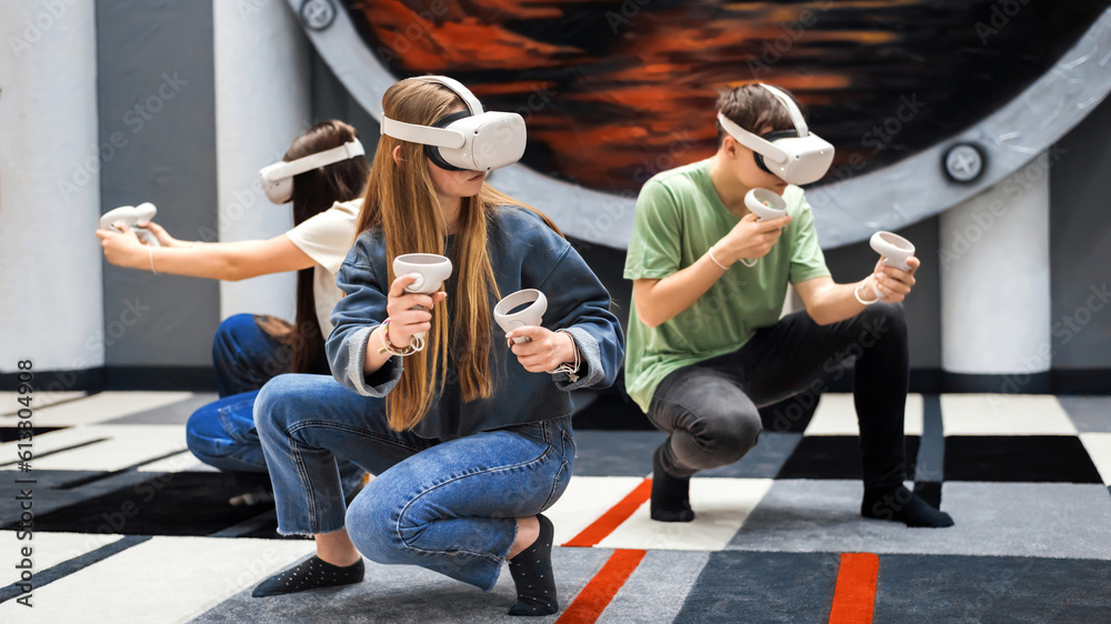 A group of teenagers playing using VR equipment
