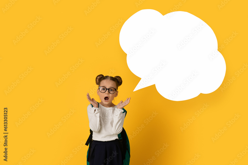 Shocked Little Schoolgirl Standing Near Blank Speech Bubble On Yellow Background Shocked Little Schoolgirl Standing Near Blank Speech Bubble On Yellow Background