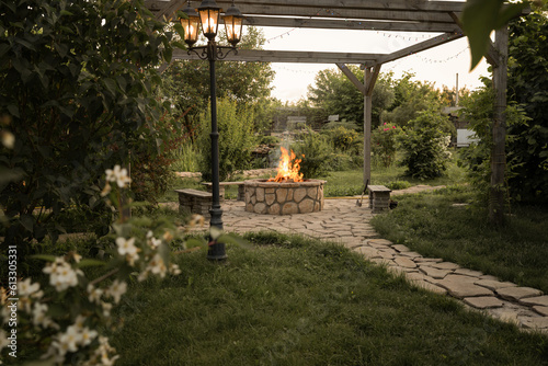 Patio and fire in the fire pit in the evening. Pleasant summer evening.