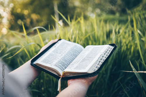 Open bible in hands close-up, concept of calmness and morning solitude photo