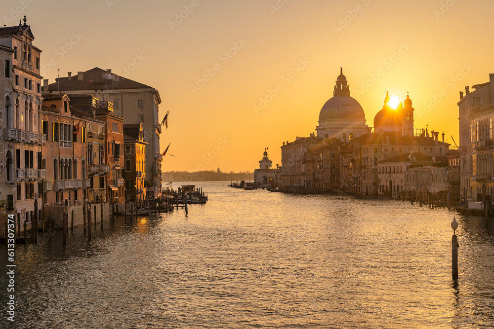 The Grand Canal in Venice with the silhouette of the Santa Maria della Salute basilica at sunrise, Italy, Europe.
