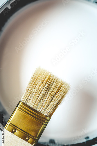 Paint brush resting on paint tin viewed from above