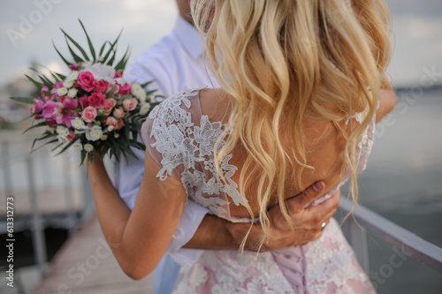 Very romantic photo. Silhouette of lovers with flowers in the hand of a fair-haired beauty.