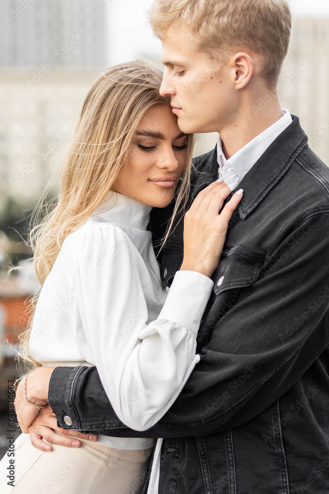 Beautiful happy young loving couple on a surprise date on a Saint Valentine's Day. Romantic modern wedding on the rooftop, summertime. Young man and beautiful girl. Newlyweds on honeymoon boho style Beautiful happy young loving couple on a surprise date on a Saint Valentine's Day. Romantic modern wedding on the rooftop, summertime. Young man and beautiful girl. Newlyweds on honeymoon boho style
