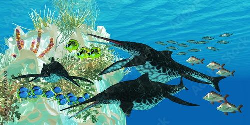 Shonisaurus Reptiles Underwater - Shonisaurus Ichthyosaurs swim among fish surrounding an underwater reef. photo