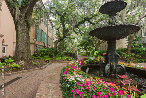 garden with fountain in the park surrounded by spanish moss and charleston south carolina architecture