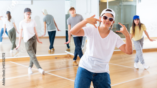 Happy girls and boy dancing hip hop in dancing class