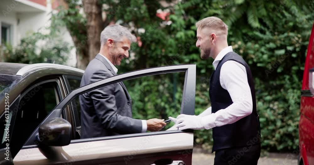 Man Giving Car Key To Male Valet