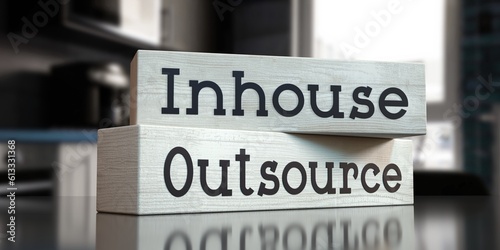 Outsource, inhouse - words on wooden blocks - 3D illustration photo