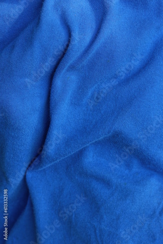 Texture of a fabric from a piece of crumpled blue cloth