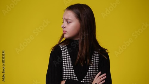 4k video of one girl with negative facial expression over yellow background.