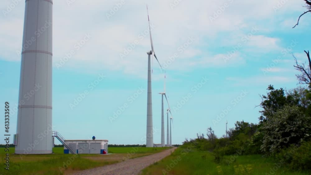 Wind turbines on green field in countryside, aerial view Wind turbines on green field in countryside, aerial view
