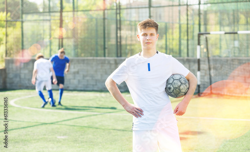 Portrait of teen boy soccer player on the field
