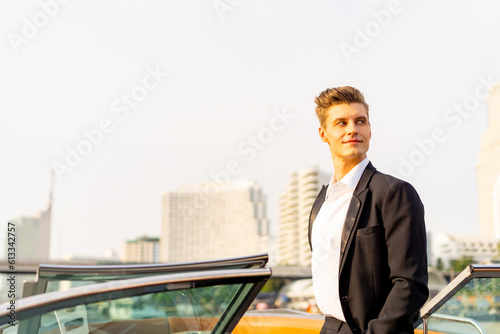 Confidence Caucasian man celebrating holiday event travel the city on luxury private yacht sailing in the river with looking beautiful cityscape skyscraper and drinking champagne at summer sunset.
