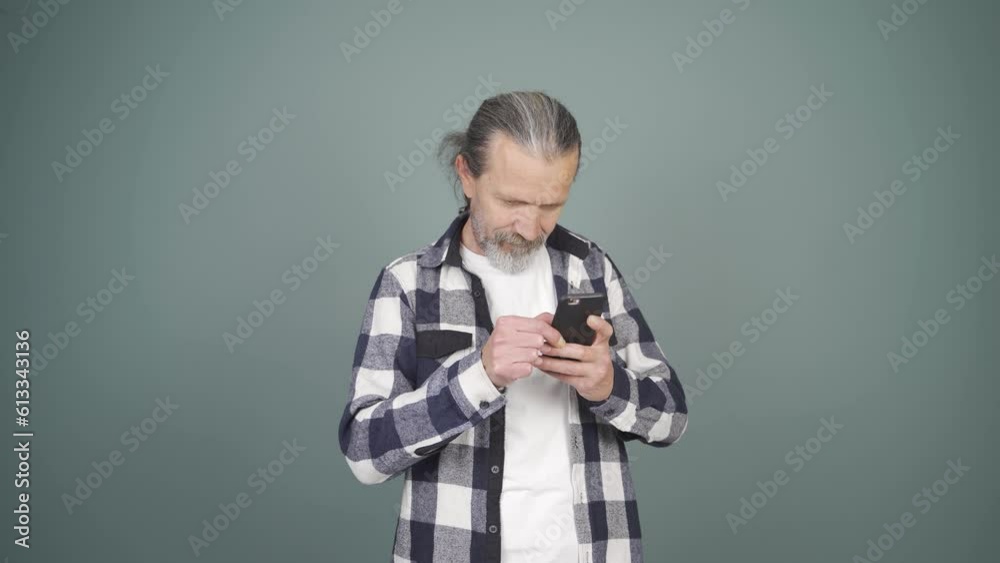 The man looking at the phone is happy. The man looking at the phone is happy.