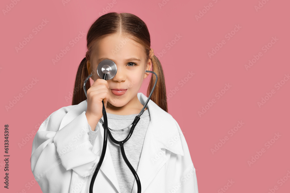 Little girl in medical uniform with stethoscope on pink background. Space for text Little girl in medical uniform with stethoscope on pink background. Space for text