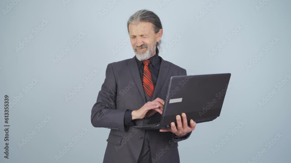 Businessman looking at laptop with scared expression. Businessman looking at laptop with scared expression.