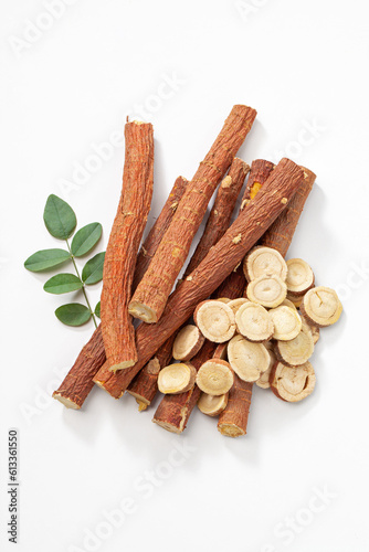 herbal medicine licorice root sticks and slices with leaf isolated on white background. photo