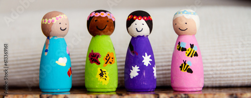 Painted wooden peg dolls of different races; small wooden dolls painted by a child