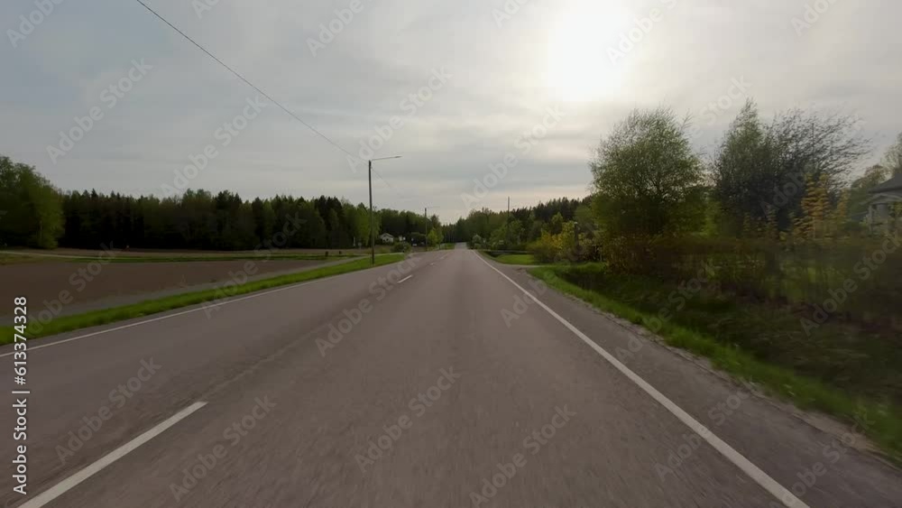 The road winds its way through the countryside, flanked by rows of majestic trees. Cars travel along the path, providing a sense of movement and vitality to the serene surroundings. The road winds its way through the countryside, flanked by rows of majestic trees. Cars travel along the path, providing a sense of movement and vitality to the serene surroundings.