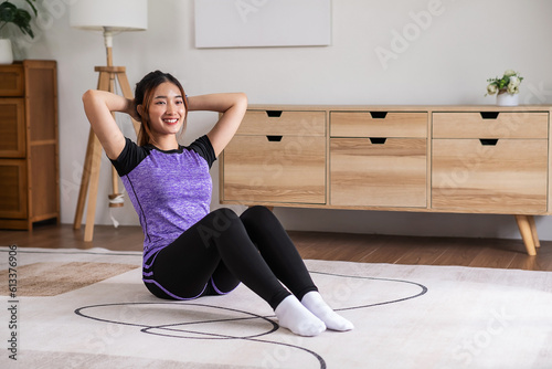 Asian woman in sports wear warm up before workout at home. home exercise concept.