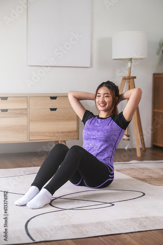 Asian woman in sports wear warm up before workout at home. home exercise concept.
