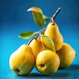 Sweet appetizing yellow pears with leaves on a blue background, fruit harvest, autumn