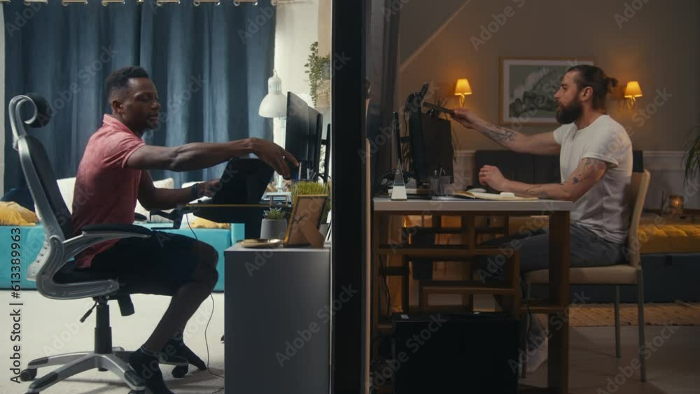 Two diverse neighbors sit at computers. One man starts working remotely, another man in headphones plays online video games. Two apartments separated by wall. Concept of neighbourhood and lifestyle. Two diverse neighbors sit at computers. One man starts working remotely, another man in headphones plays online video games. Two apartments separated by wall. Concept of neighbourhood and lifestyle.