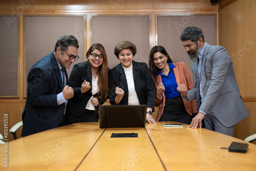 Wallpaper Mural Indian businesspeople and employee giving happy expression after looking in laptop at office. Torontodigital.ca