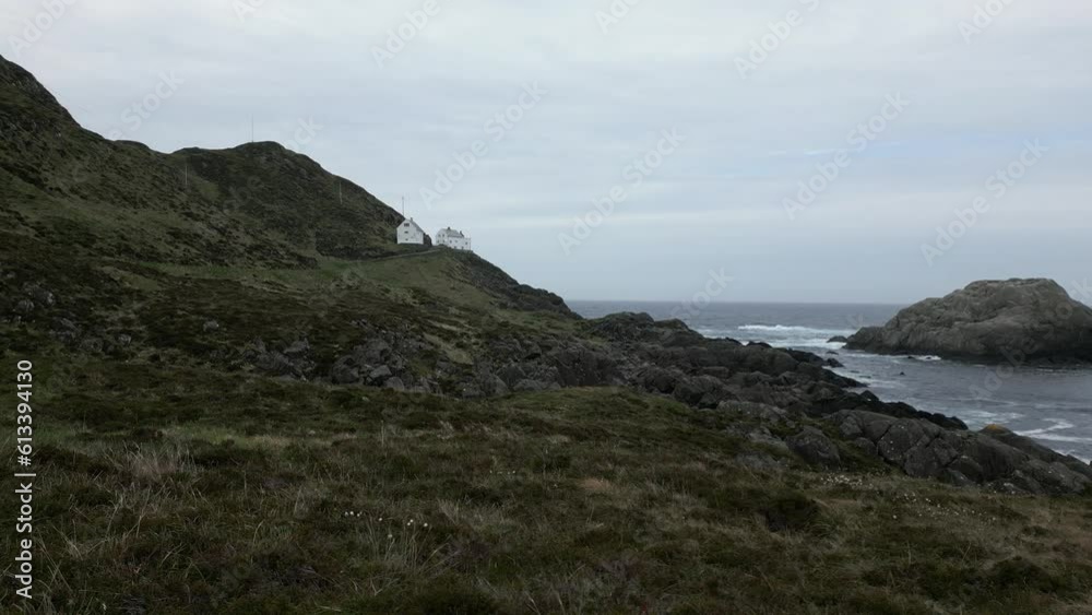 Still Video of Kråkenes Lighthouse at a Far Distance on a Windy and Moody Day. Close to Måløy, Kinn Municipality, Norway. Still Video of Kråkenes Lighthouse at a Far Distance on a Windy and Moody Day. Close to Måløy, Kinn Municipality, Norway.