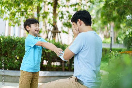 Lovely Asian little young boy giving his daddy the greeting card for the international father's day, lovely boy gives his father a drawing DIY Father's Day greeting card.
