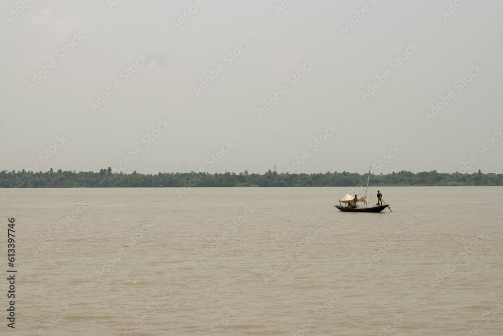 silhouette of traditional local boat inside bhagirathi river at barul in the watery landscape 