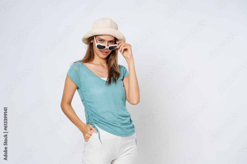 Young woman in sunglasses wearing, colorful clothes and hat, isolated over white background.Lifestyle summer concept. Young woman in sunglasses wearing, colorful clothes and hat, isolated over white background.Lifestyle summer concept.