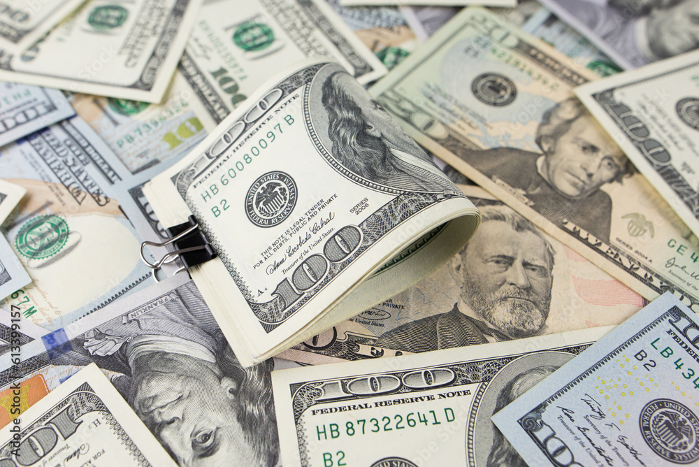One hundred dollars close-up in large quantities lie on the table. Much money. One hundred dollars close-up in large quantities lie on the table. Much money.
