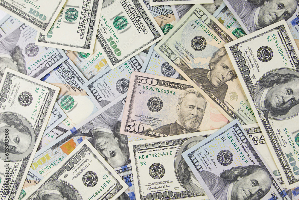 One hundred dollars close-up in large quantities lie on the table. Much money. One hundred dollars close-up in large quantities lie on the table. Much money.