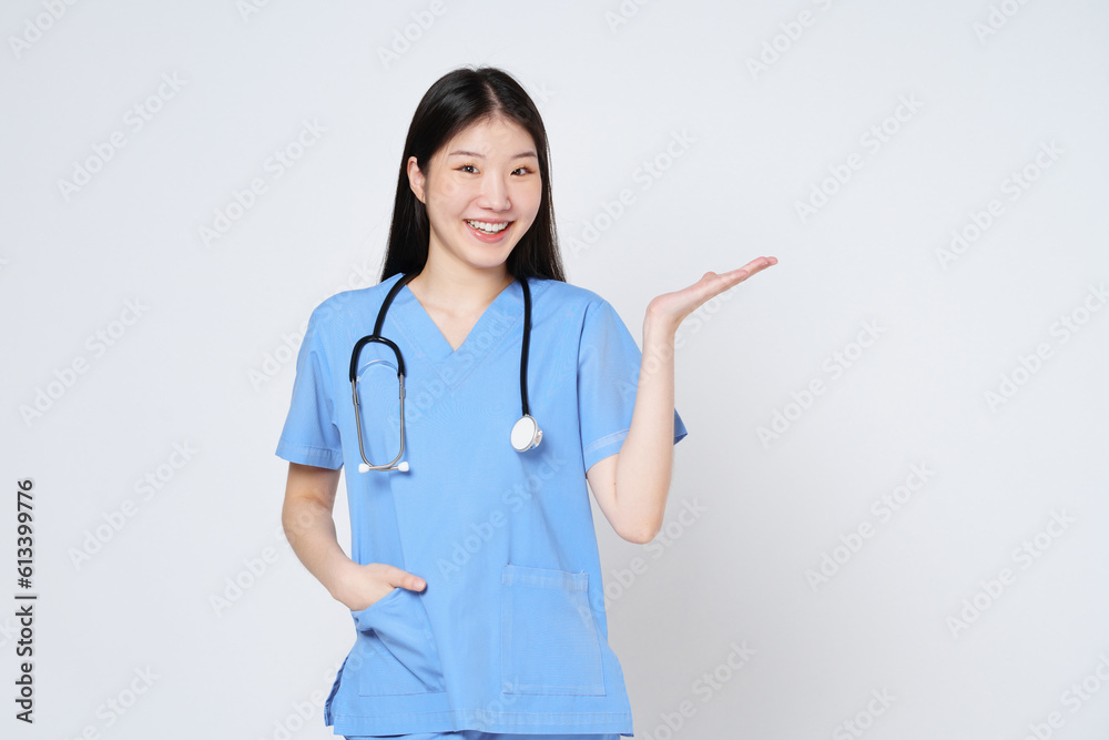 Young doctor woman wearing a stethoscope and showing open hand palm with copy space for product isolated on white background. Young doctor woman wearing a stethoscope and showing open hand palm with copy space for product isolated on white background.