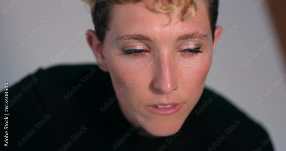In an intense closeup portrait, a model looks up at the camera, and off to the side. In an intense closeup portrait, a model looks up at the camera, and off to the side.