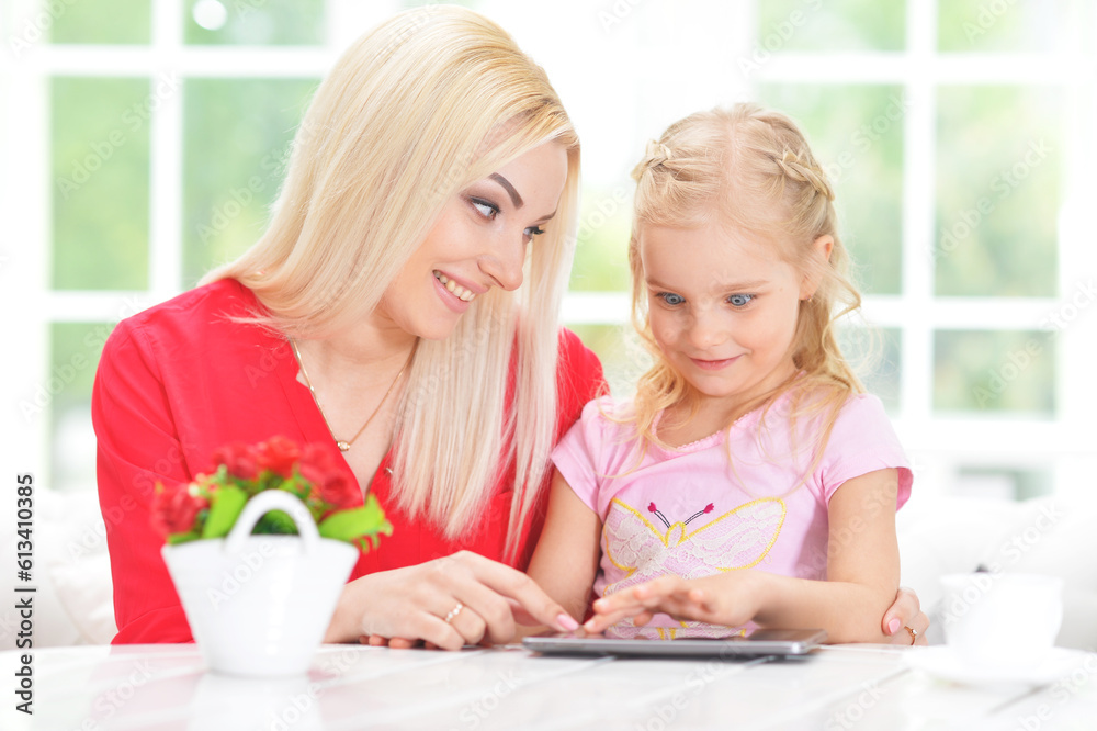 mother and daughter using tablet computer mother and daughter using tablet computer