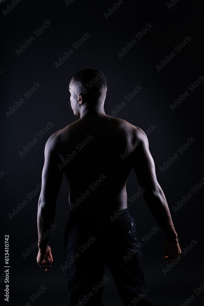 Naklejka premium Muscle, body and skin, portrait of black man on dark background with serious face for art aesthetic.