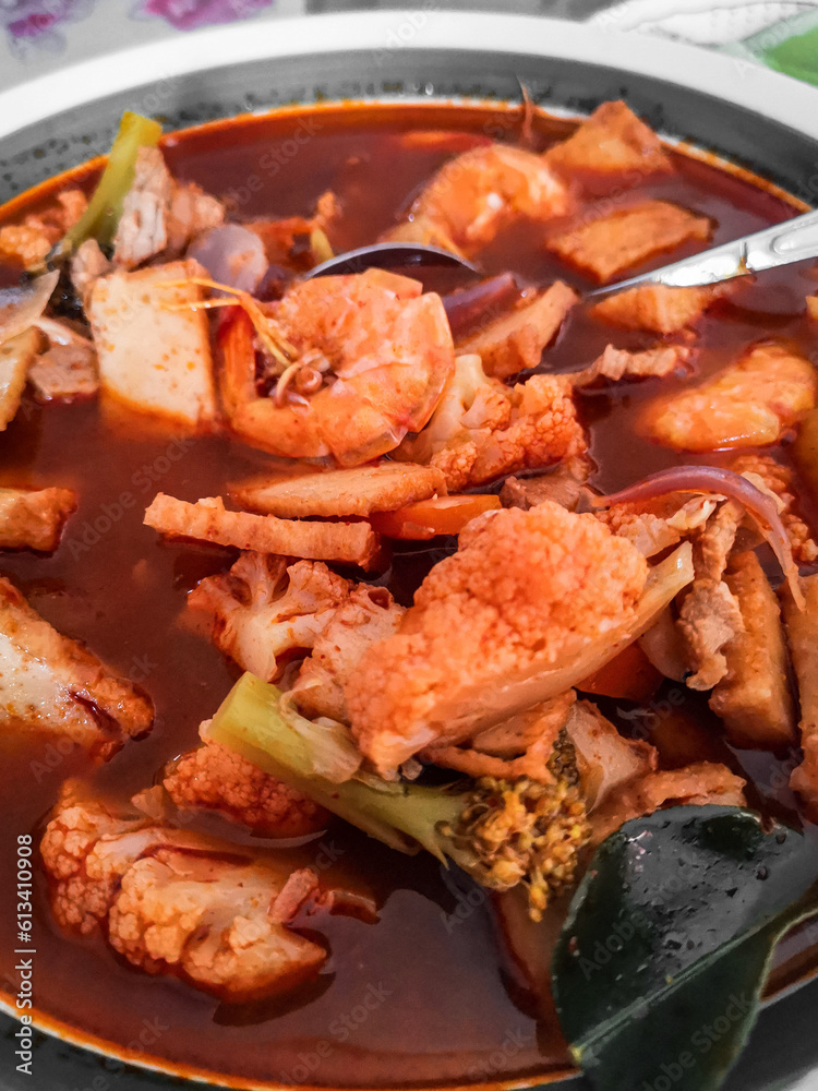 Tom yum kung Spicy Thai soup with shrimp and vegetable in a bowl. Top view, copy space.
