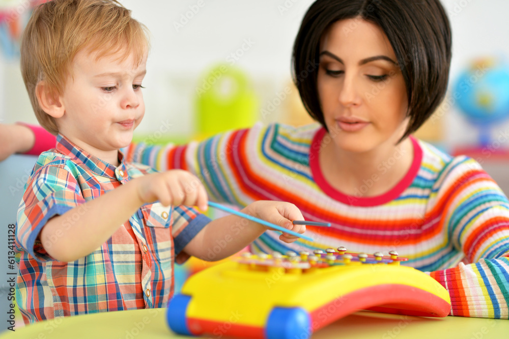 Young mother and cute little son playing Young mother and cute little son playing