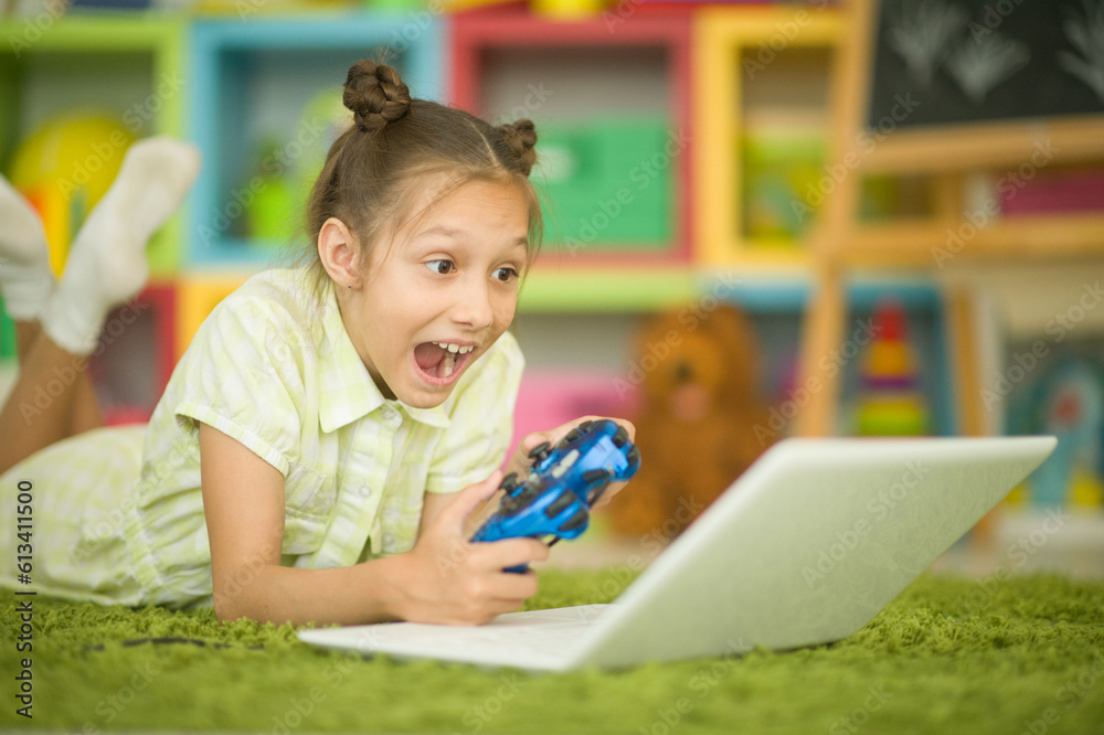 Teenage girl with laptop lying on cozy carpet at home. Teenage girl with laptop lying on cozy carpet at home.