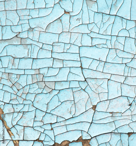 Cracked blue paint on the surface of the old wall as a background