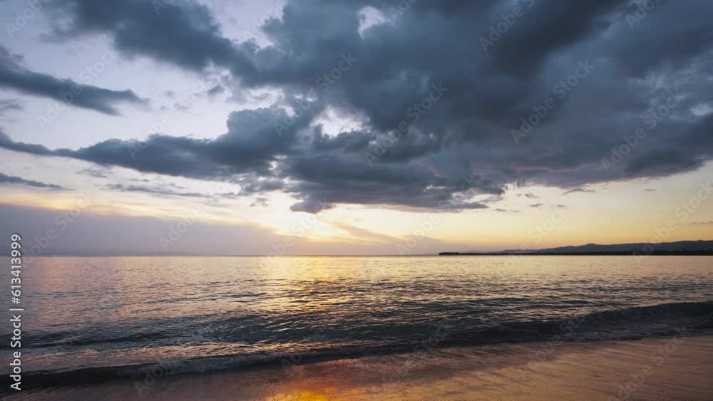 Landscape view of calm waves of sea water with orange sunlight at sunset. Evening beach on the island. exotic coast. Summer holidays, rest in amazing picturesque nature. Relaxing paradise.
