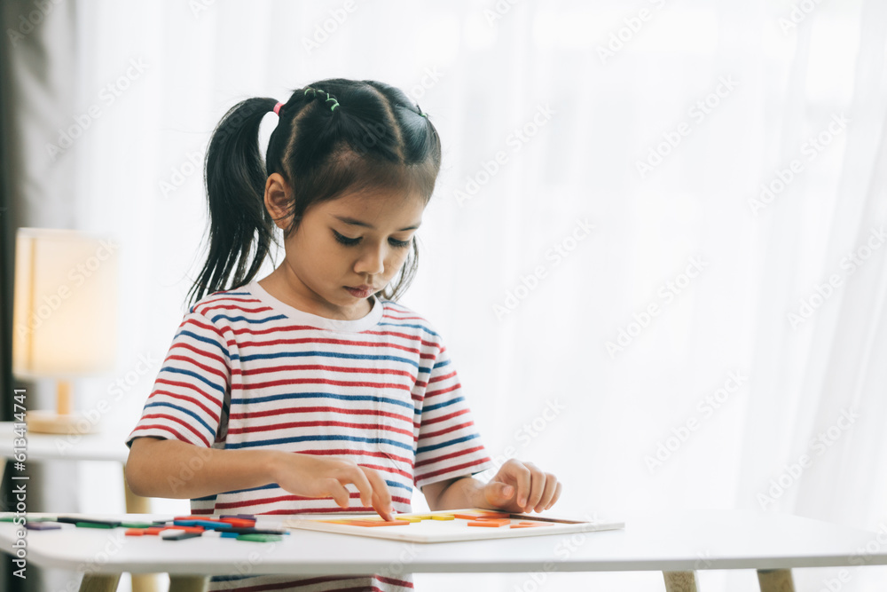 little asian child girl playing with colorful plasticine in living room at home little asian child girl playing with colorful plasticine in living room at home