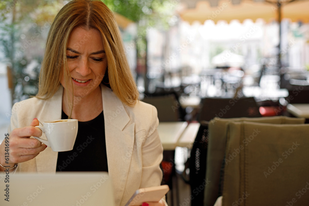 A young businesswoman is enjoying herself in a coffee shop, taking a break from work. A young businesswoman is enjoying herself in a coffee shop, taking a break from work.