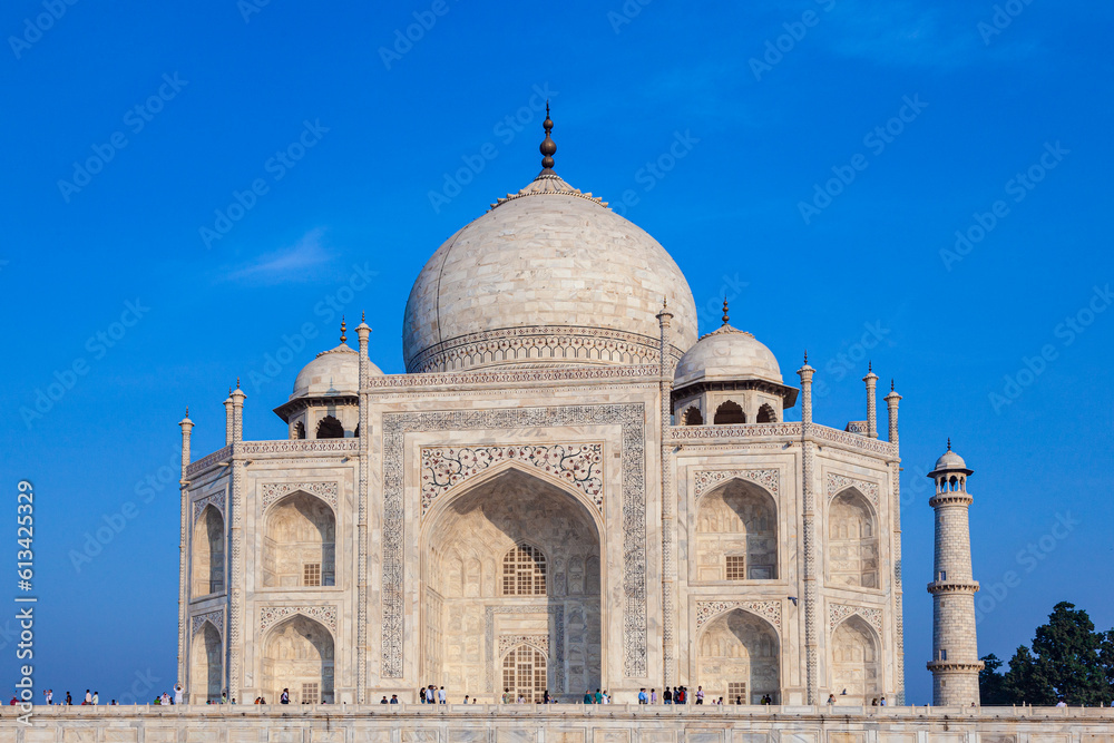 Taj Mahal in India under blue sky with the inscription of the coran in arabic letter meaning in english: This is an invitation to live on Earth as a good Muslim
