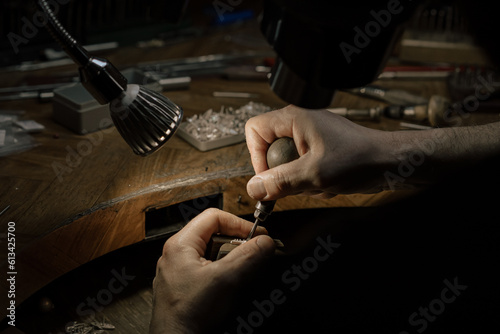 Hands of an artisan jeweler working jewelry. Jewelry Goldsmith