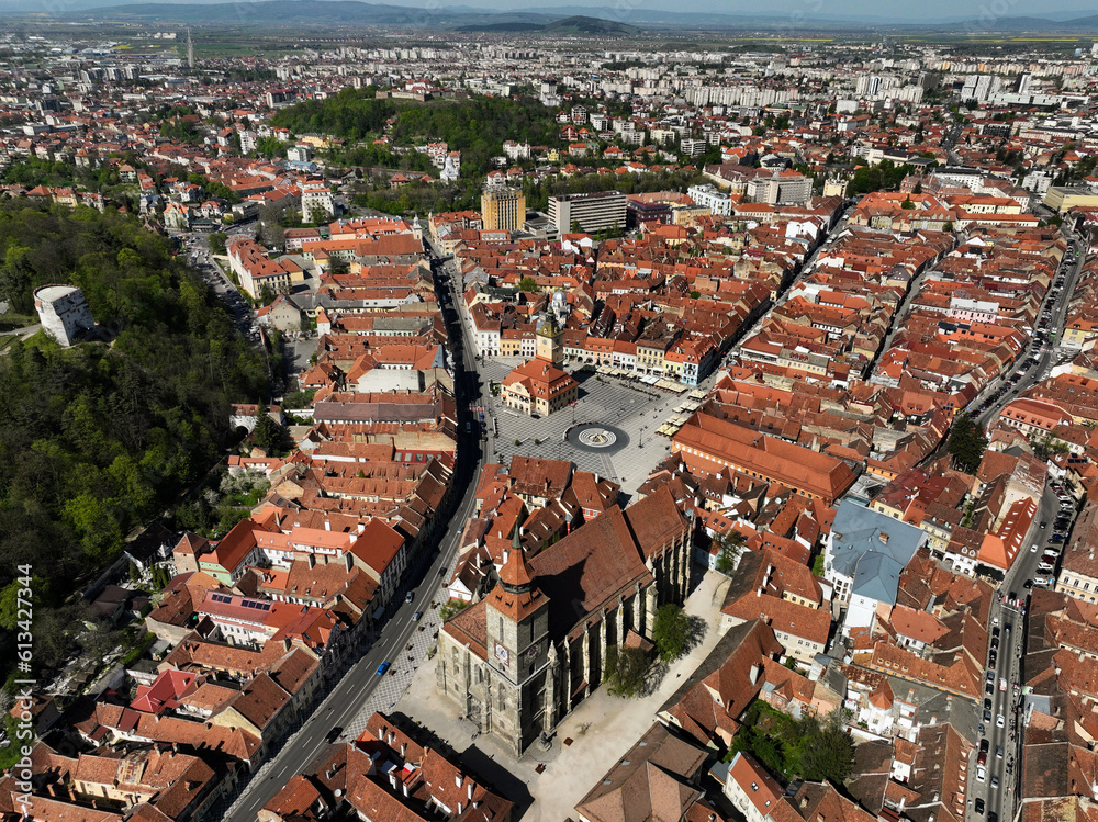 An aerial view of the Council Square in Brasov, Romania. The square is adorned with beautiful medieval buildings that stand as testaments to the city's rich architectural heritage.